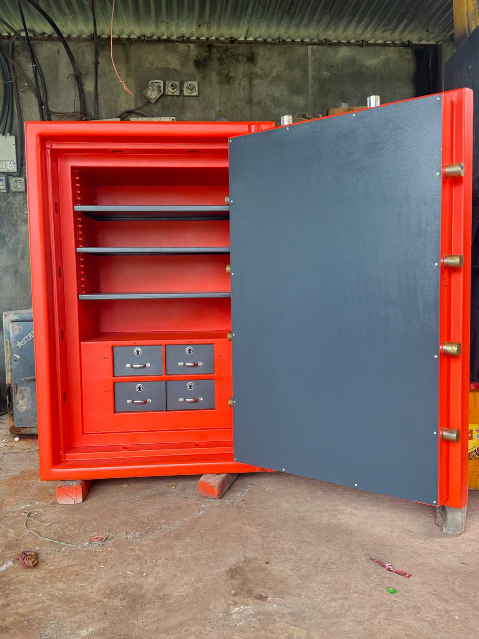 Open red Ajanta vault showing shelves and internal safe-deposit drawers