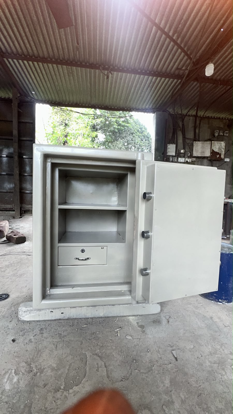 Open white Ajanta safe showing shelves, lock hardware, and inner compartment